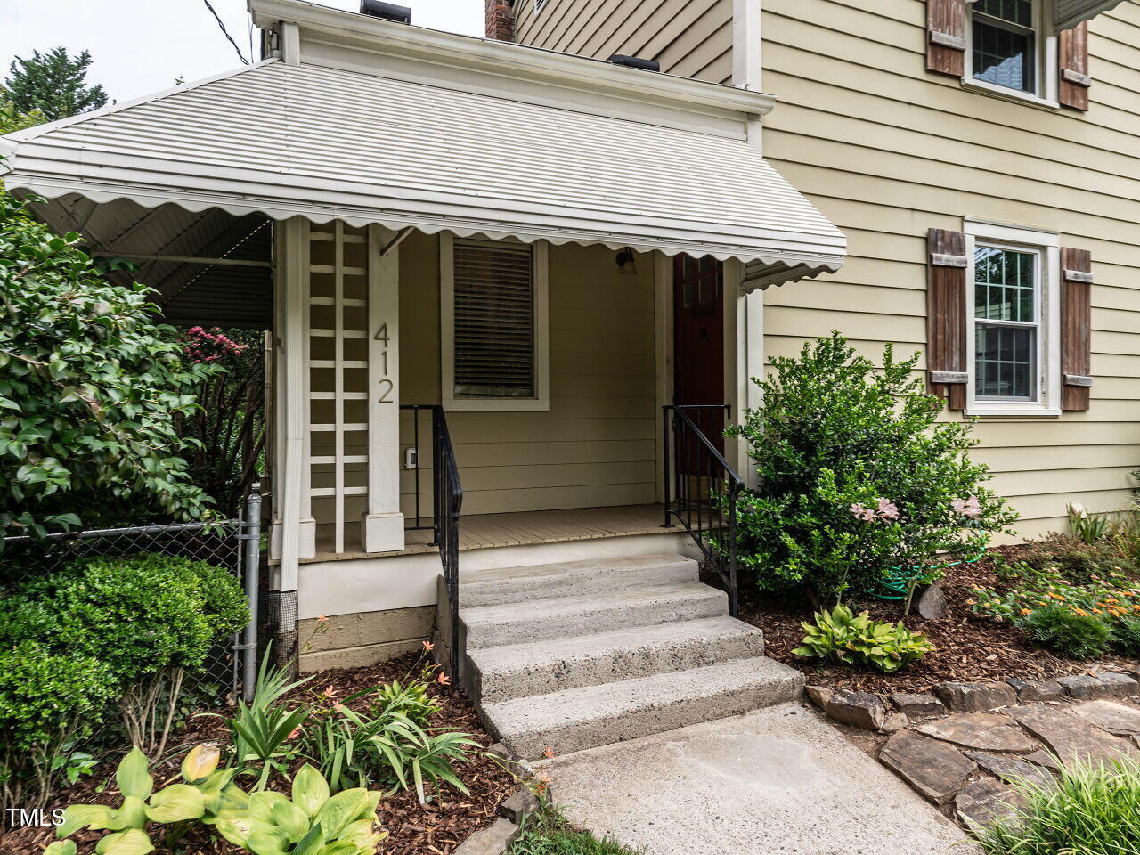 412 Morrison Avenue Raleigh, NC 27608 - Photo 2 of 26 a front view of a house with a garden
