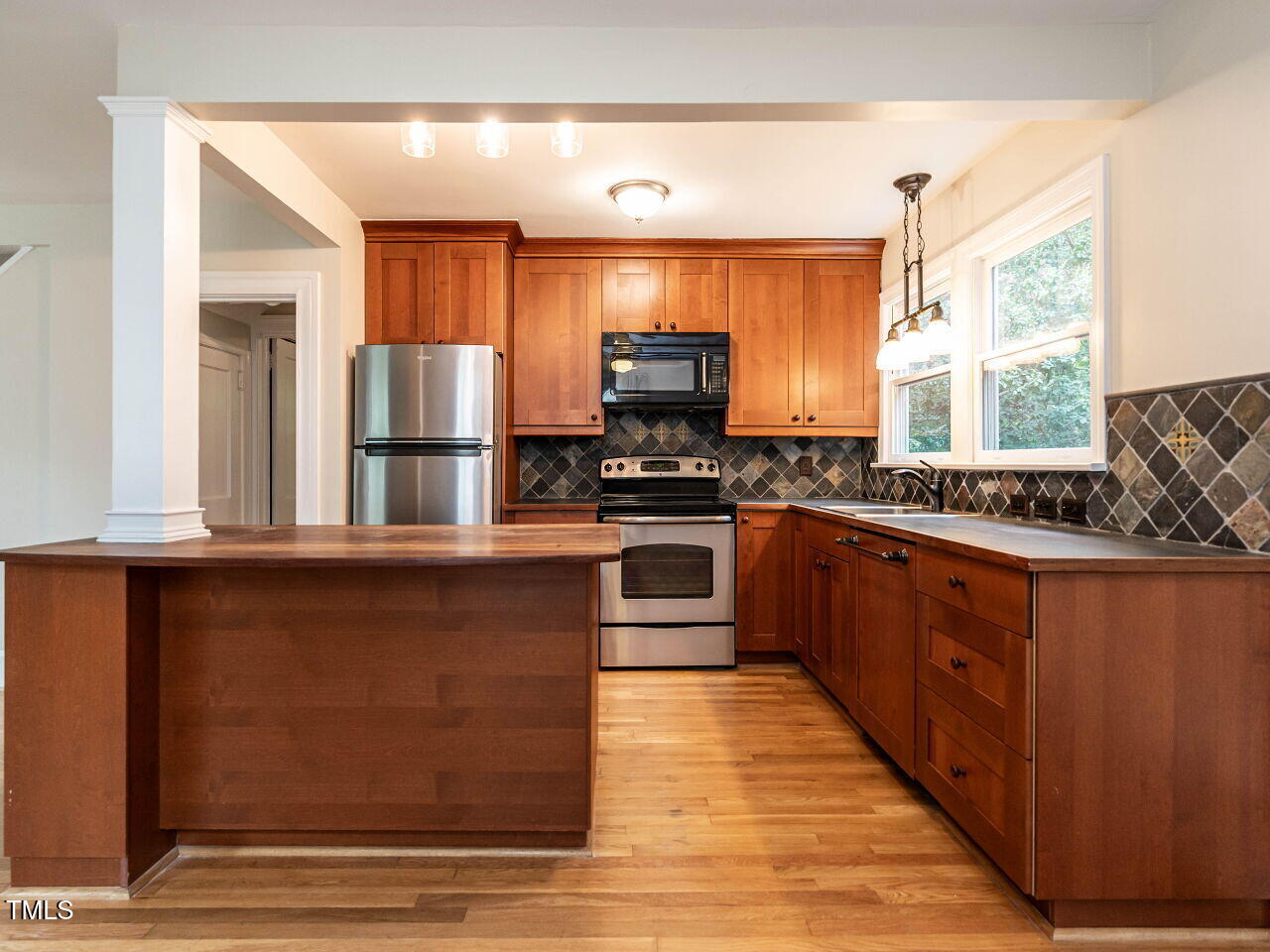 412 Morrison Avenue Raleigh, NC 27608 - Photo 7 of 26 a kitchen with stainless steel appliances granite countertop a stove a sink and a refrigerator