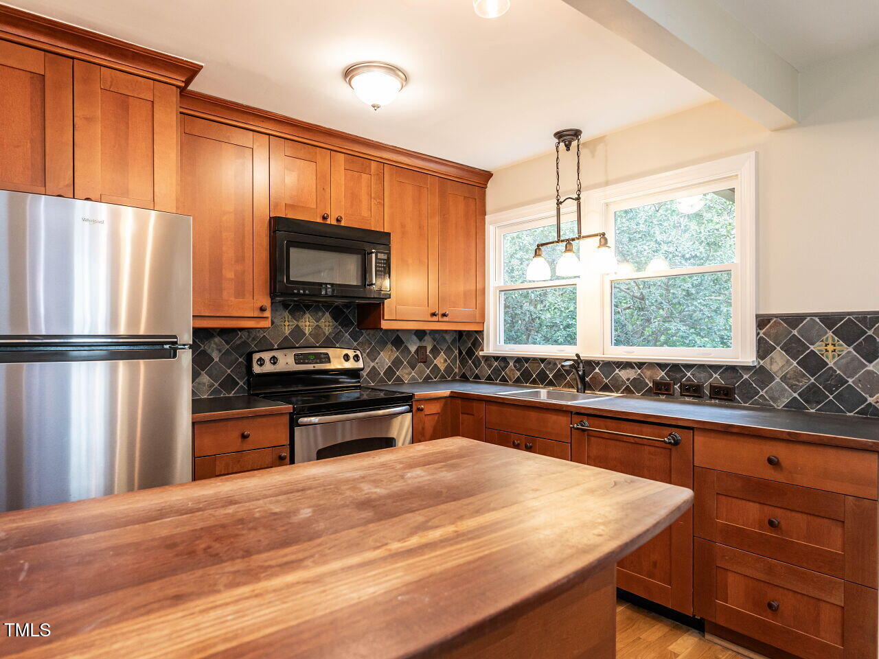 412 Morrison Avenue Raleigh, NC 27608 - Photo 9 of 26 a kitchen with stainless steel appliances granite countertop a refrigerator and a stove top oven