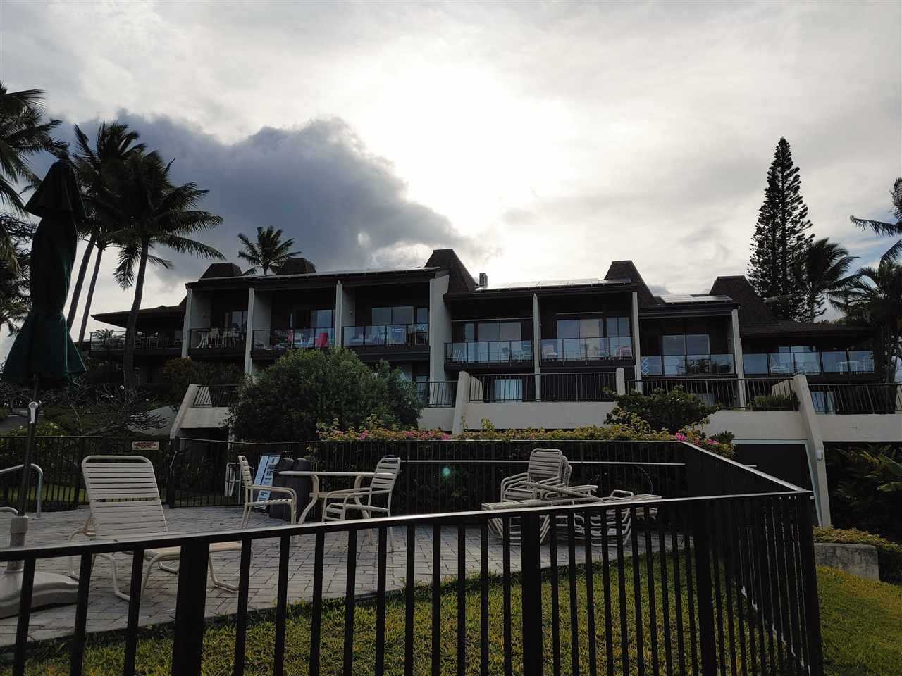5295 Lower Honoapiilani Road, Unit A24 Lahaina, HI 96761 - Photo 18 of 23 a front view of a house with a yard