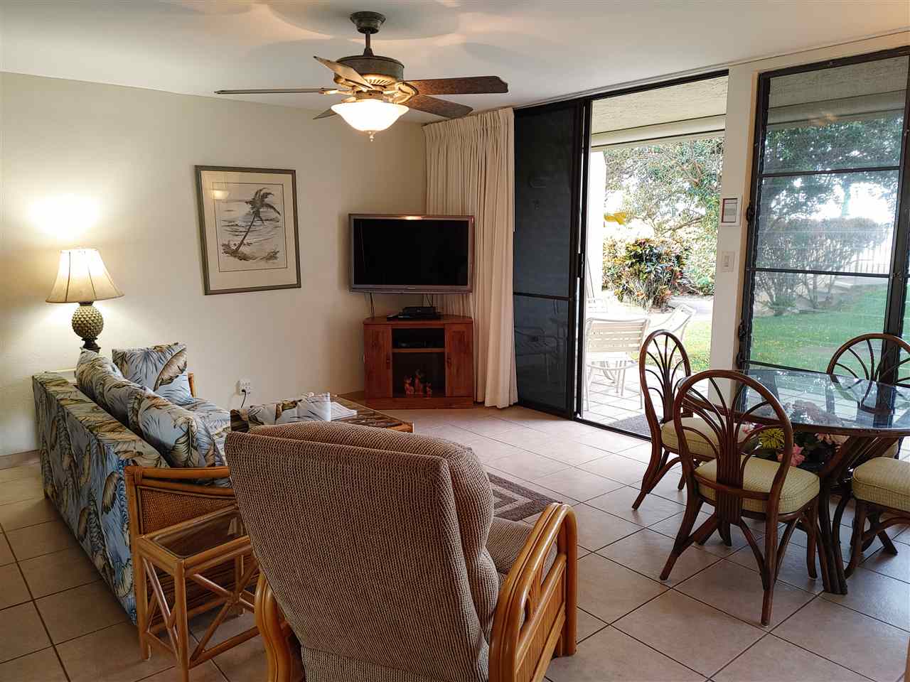 5295 Lower Honoapiilani Road, Unit A24 Lahaina, HI 96761 - Photo 21 of 23 a living room with furniture a flat screen tv and a large window