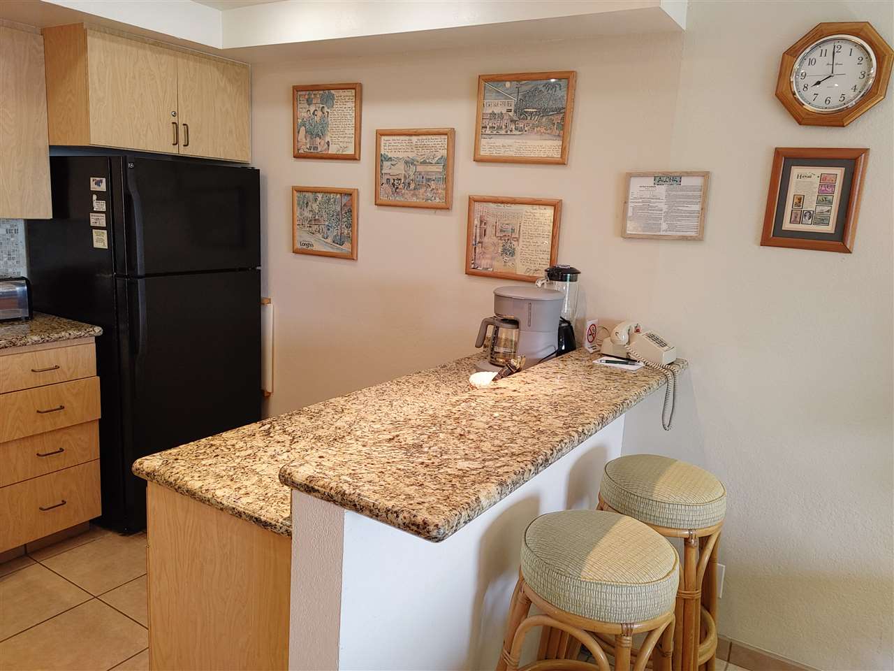 5295 Lower Honoapiilani Road, Unit A24 Lahaina, HI 96761 - Photo 22 of 23 a bathroom with a granite countertop sink and a refrigerator