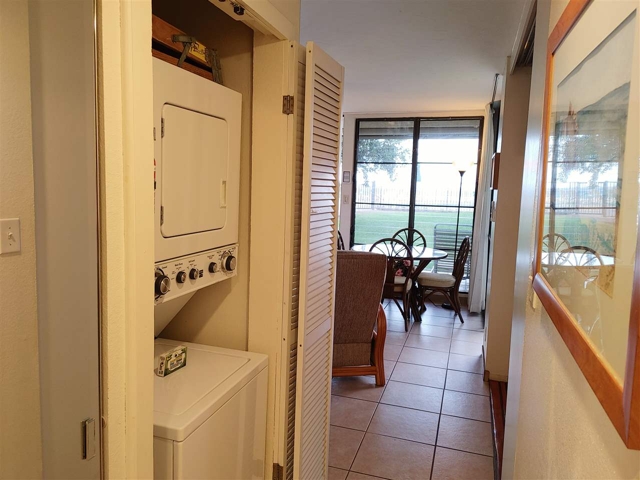 5295 Lower Honoapiilani Road, Unit A24 Lahaina, HI 96761 - Photo 5 of 23 a dining room with furniture and a floor to ceiling window
