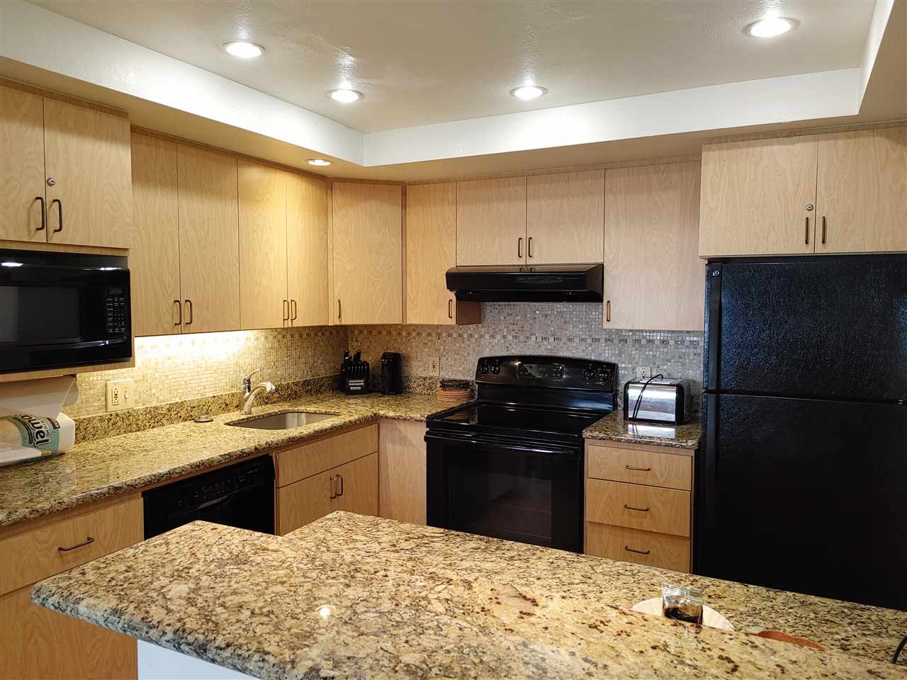5295 Lower Honoapiilani Road, Unit A24 Lahaina, HI 96761 - Photo 8 of 23 a kitchen with a sink and cabinets