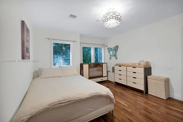 a bedroom with a bed and a chandelier