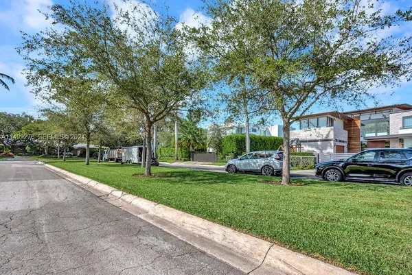 a view of a house with a car park side of the road