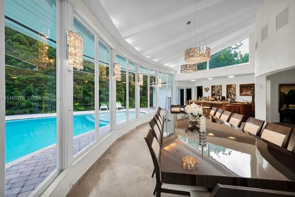a view of a dining room with furniture large windows and wooden floor