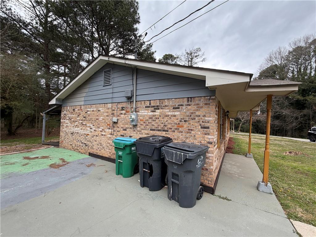 1775 Highpoint Road Snellville, GA 30078 - Photo 3 of 11 a view of a patio with table and chairs under an umbrella