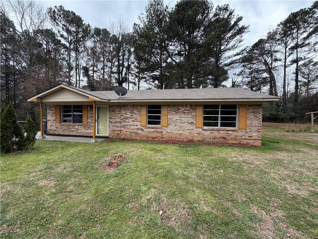 1775 Highpoint Road Snellville, GA 30078 - Photo 4 of 11 a front view of a house with a garden