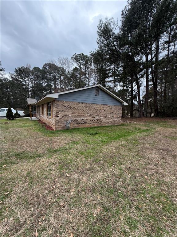 1775 Highpoint Road Snellville, GA 30078 - Photo 5 of 11 a view of a house with a yard and sitting area