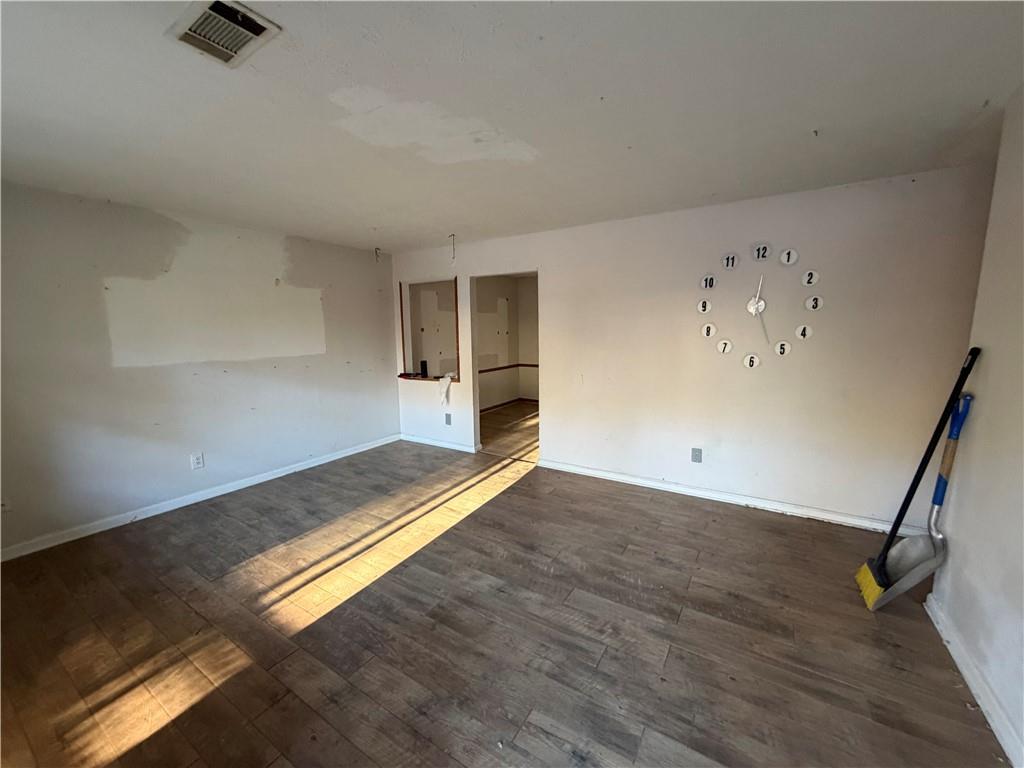 1775 Highpoint Road Snellville, GA 30078 - Photo 7 of 11 a view of a room with wooden floor and a ceiling fan