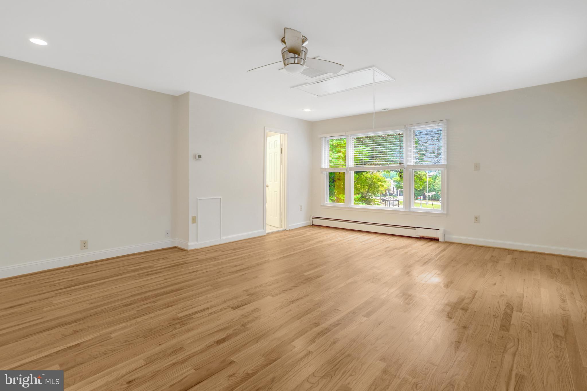 411 North Bryan Street Arlington, VA 22201 - Photo 12 of 58 an empty room with wooden floor and windows