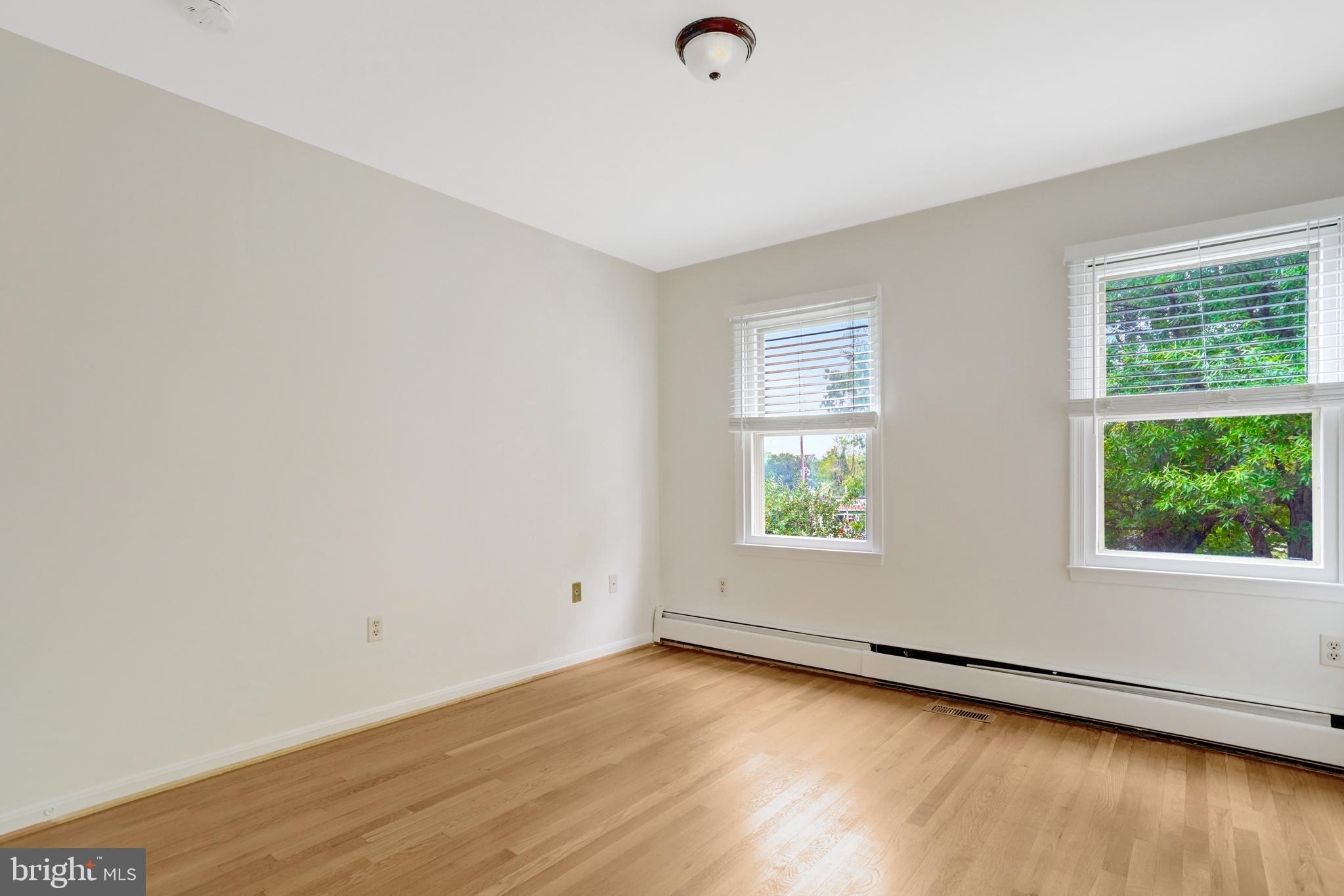 411 North Bryan Street Arlington, VA 22201 - Photo 42 of 58 an empty room with wooden floor and windows