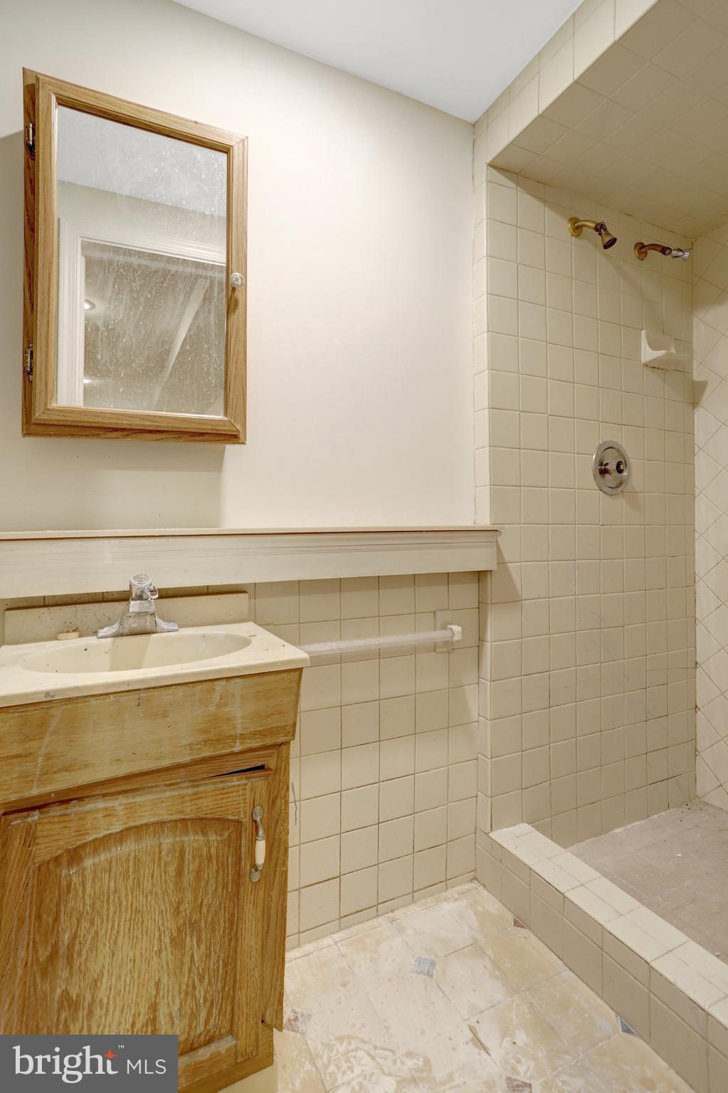 411 North Bryan Street Arlington, VA 22201 - Photo 53 of 58 a bathroom with a granite countertop sink a toilet and shower