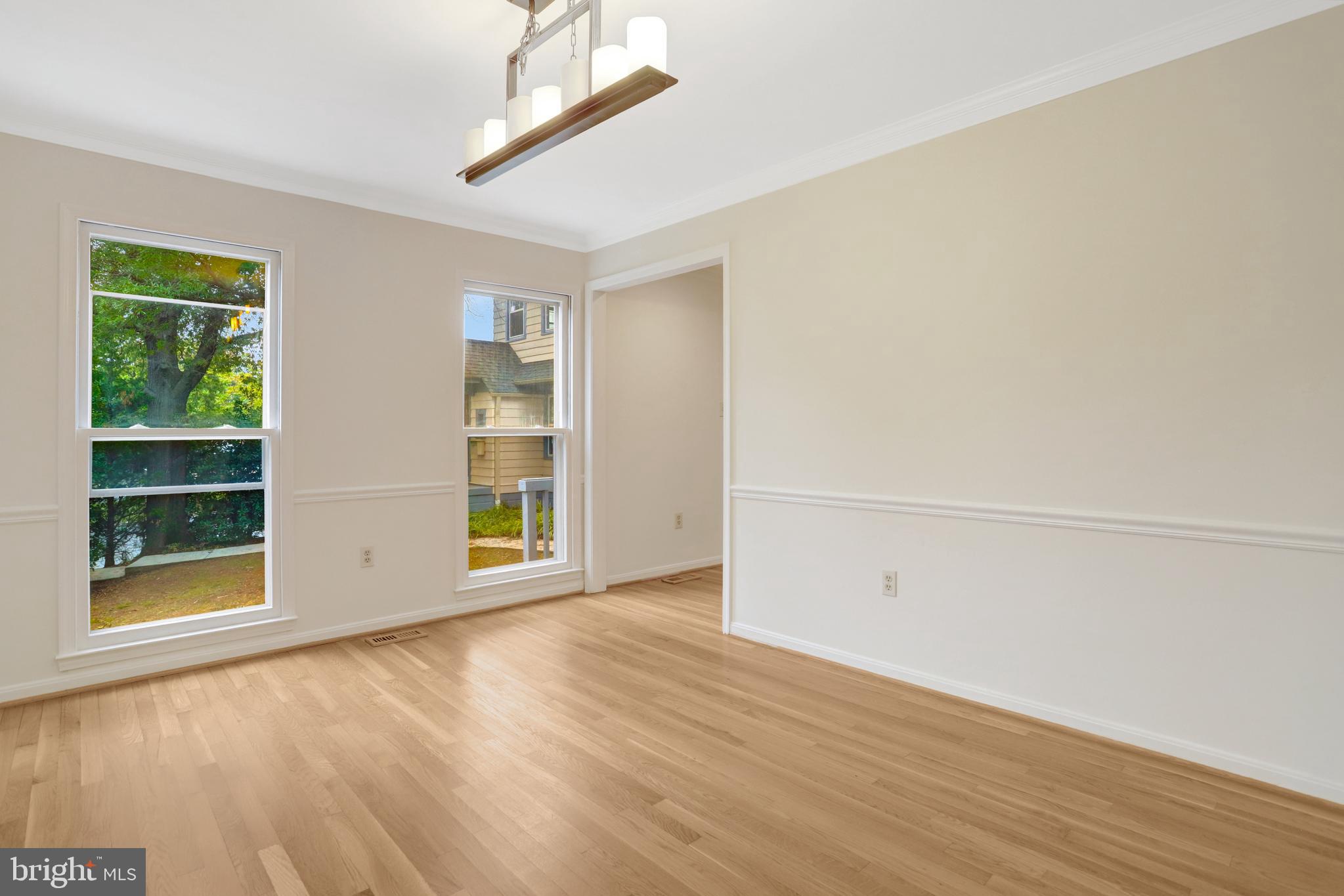 411 North Bryan Street Arlington, VA 22201 - Photo 10 of 58 an empty room with wooden floor and windows