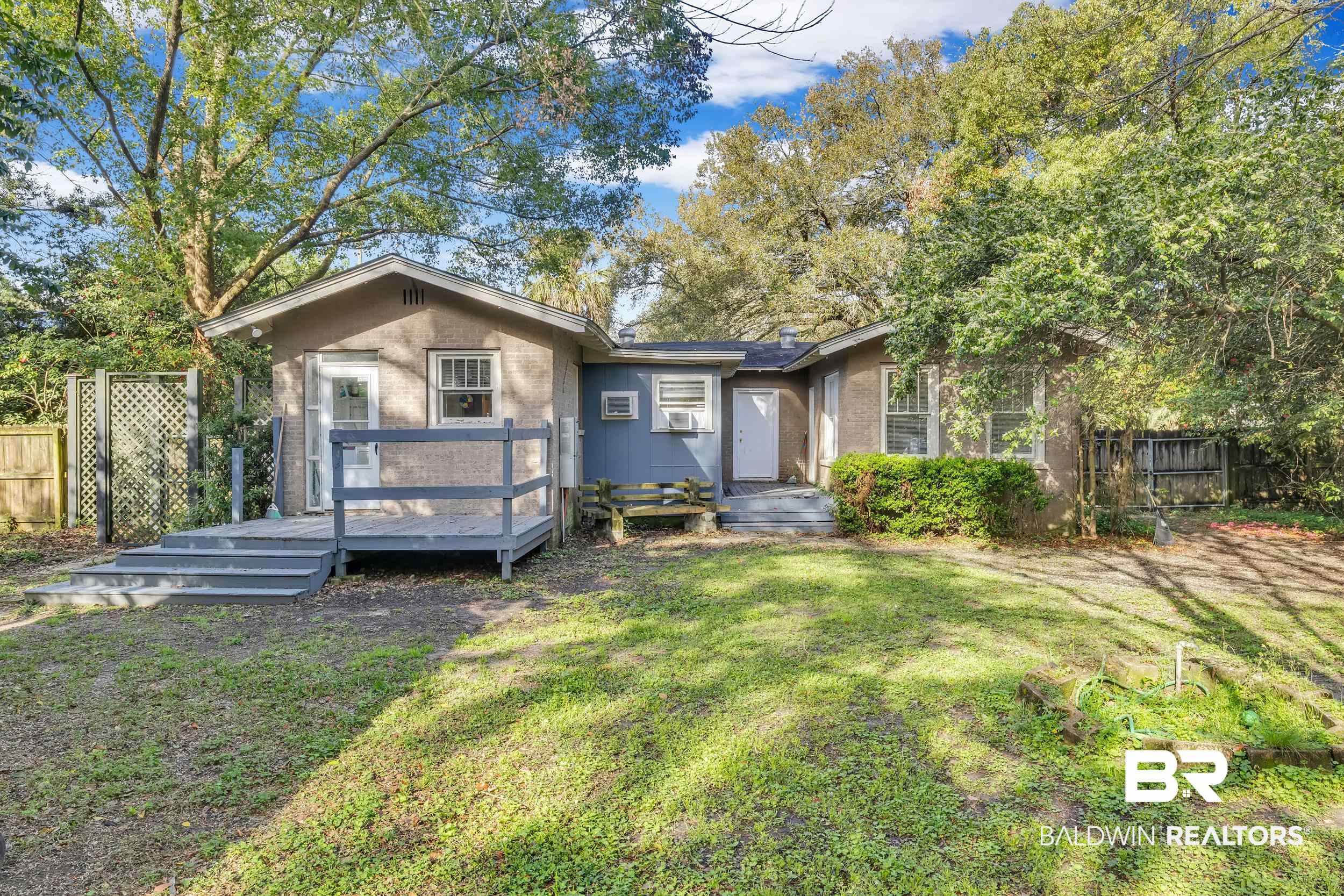 55 Mohawk Street Mobile, AL 36606 - Photo 12 of 28 Bungalow-style house with a deck, a front lawn, fence, and brick siding