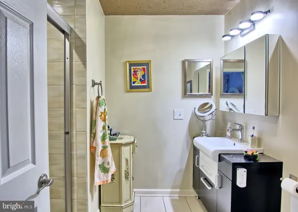 a bathroom with a sink mirror and vanity