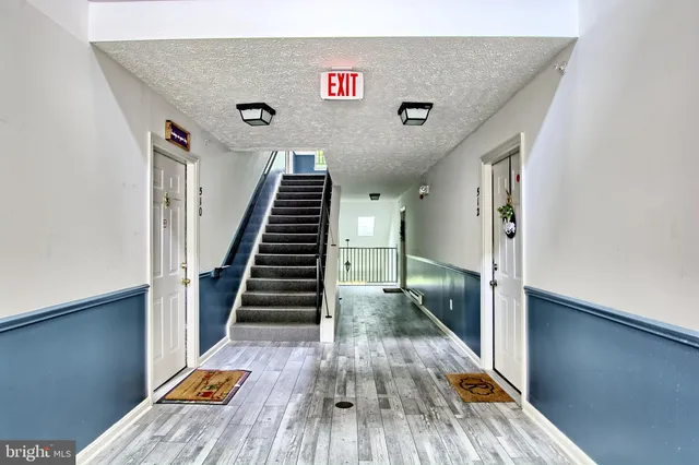a view of entryway and hall with wooden floor