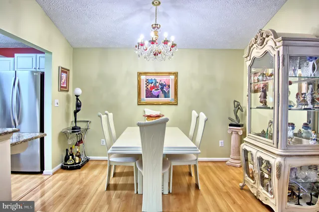 a view of a dining room with furniture wooden floor and a chandelier