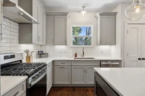 a kitchen with a sink stove and cabinets