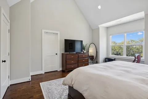 a bedroom with a bed and a flat screen tv
