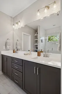 a bathroom with a sink double vanity and a mirror