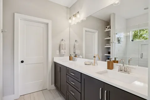 a bathroom with a double vanity sink mirror and double
