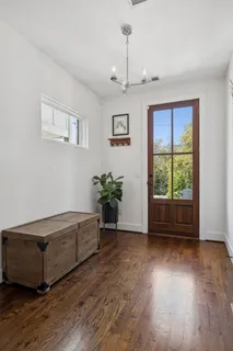 a living room with hard wood floors and a ceiling fan