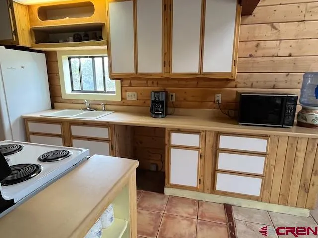 a view of a livingroom with furniture and a potted plant