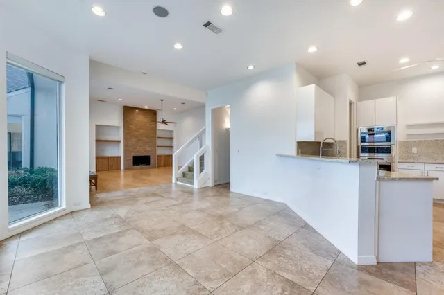 a view of a kitchen with refrigerator and a counter top