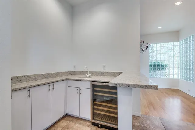 a kitchen with granite countertop a sink and cabinets