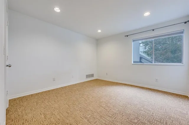 a view of an empty room and a hallway