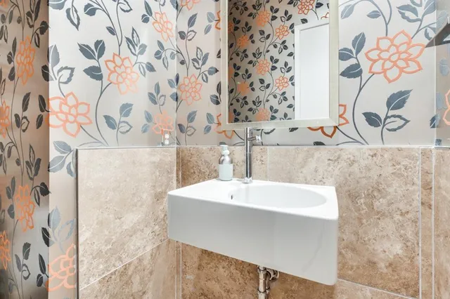 a bathroom with a sink toilet double vanity and tub