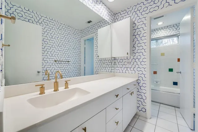 a view of a yard with plants and a large tree