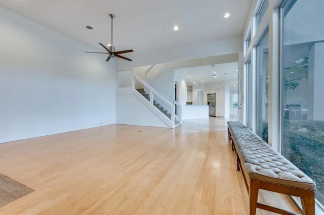 a view of a hallway with wooden floor and staircase