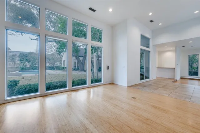 a view of hallway with wooden floor and windows