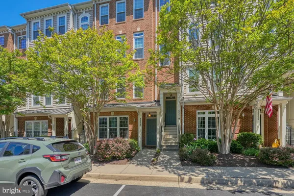 a front view of a residential apartment building with yard