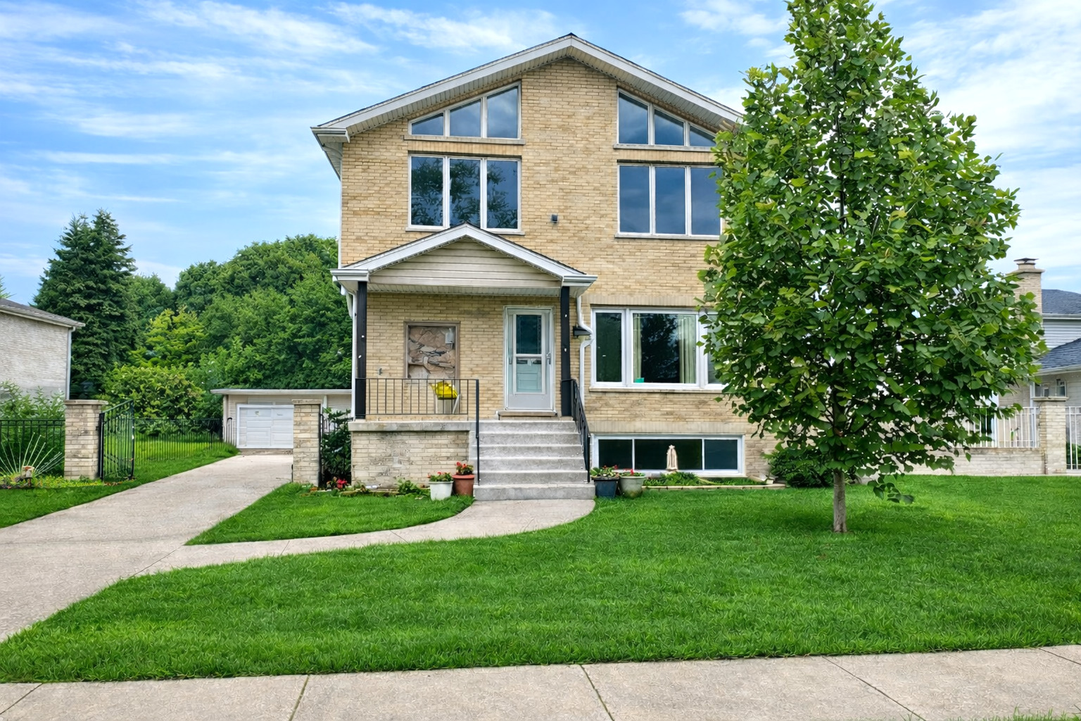 a front view of a house with a garden and yard