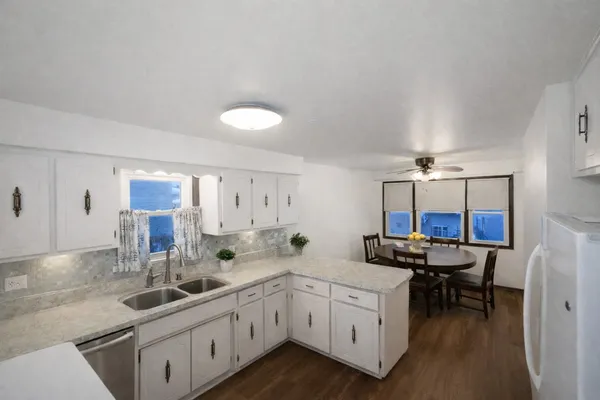 a kitchen with stainless steel appliances a sink stove and cabinets