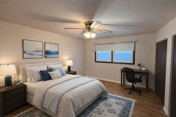 a bedroom with a bed and a chandelier