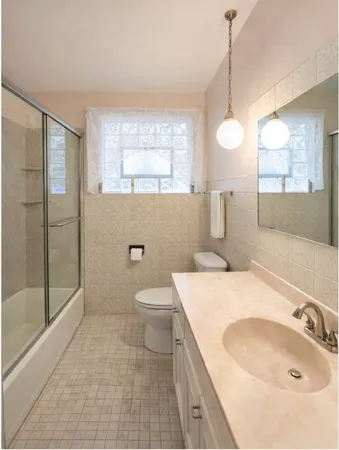 a bathroom with a sink a toilet and shower