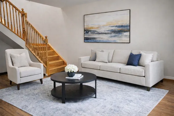 a living room with furniture and a rug