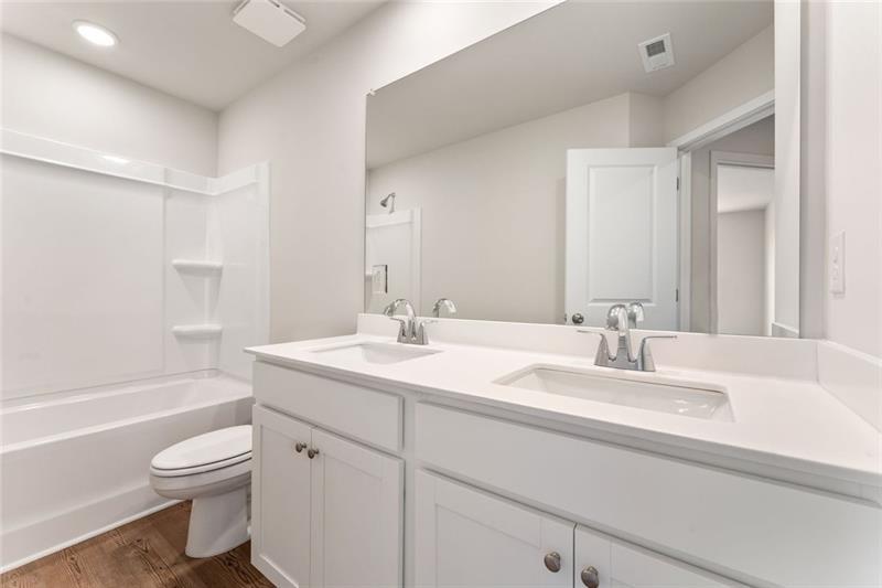 1303 Farmers Loop Austell, GA 30106 - Photo 20 of 21 a bathroom with a granite countertop toilet a sink and a bathtub