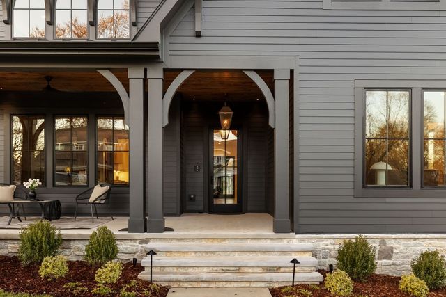 a view of a kitchen with kitchen island a sink wooden floor and living room view