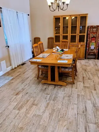 a dining room with furniture and window
