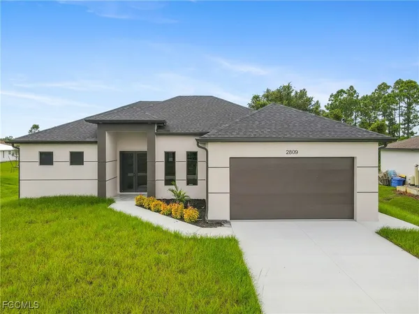 a front view of house with yard and outdoor seating