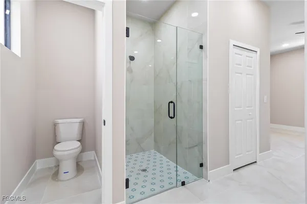 a bathroom with a shower toilet and sink