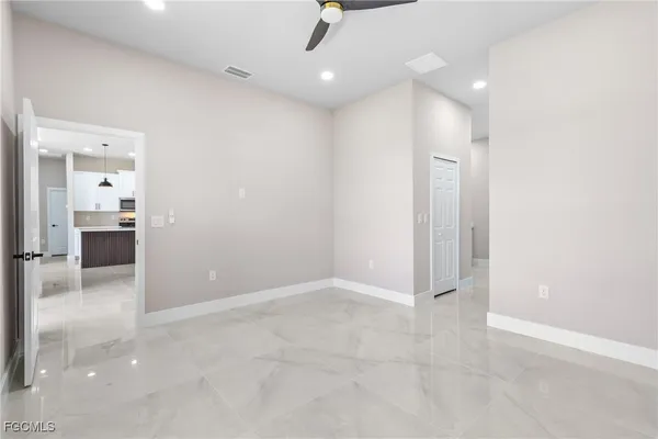 an empty room with kitchen and sink