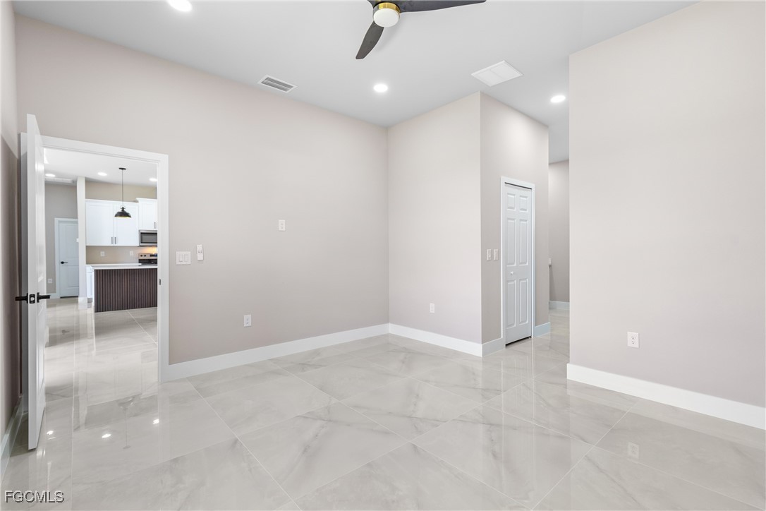 2809 25th Street Southwest Lehigh Acres, FL 33976 - Photo 15 of 36 an empty room with kitchen and sink
