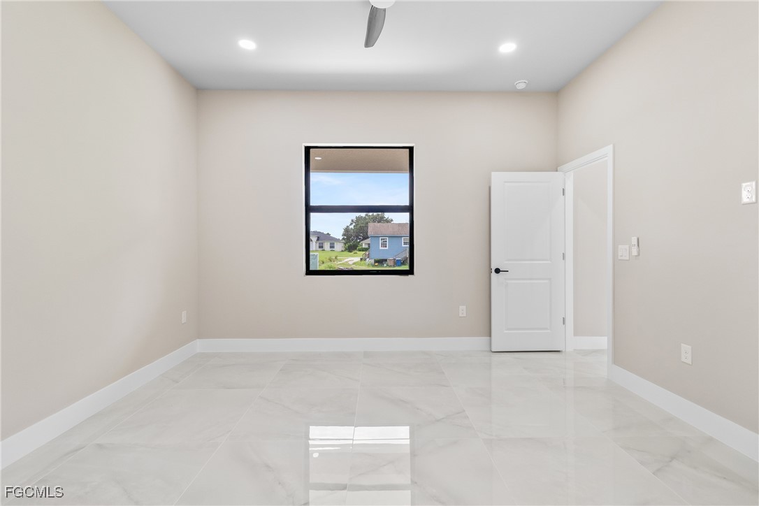 2809 25th Street Southwest Lehigh Acres, FL 33976 - Photo 17 of 36 an empty room with windows